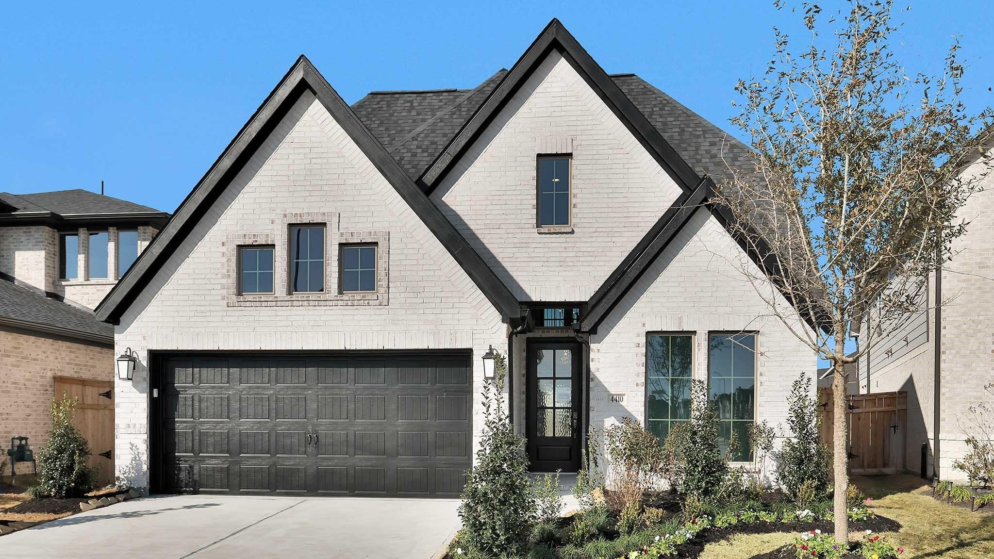 White brick new construction home with black accents in Houston